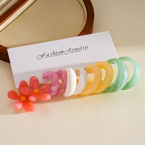 Detailed view of 10-piece colorful resin flower and hoop earring set in dopamine colors