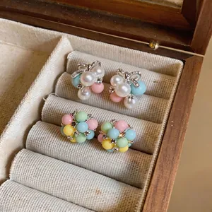 Colorful macaron acrylic bead stud earrings and pearl bow earrings in vintage jewelry box