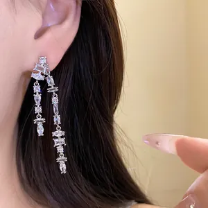 Close-up of elegant silver tassel earrings featuring sparkling cubic zirconia stones