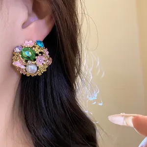 Exquisite vintage floral stud earring with colorful rhinestones and pearl detail.