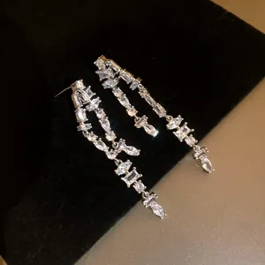Close-up of elegant silver tassel earrings with sparkling clear cubic zirconia stones