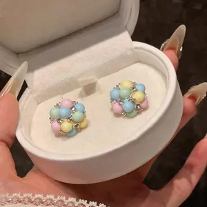 Detailed close-up view of macaron colored acrylic bead cluster earrings with rhinestones