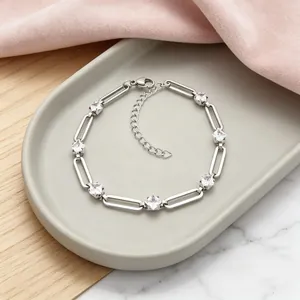 Detailed view of silver stainless steel paperclip chain bracelet with rhombic crystals