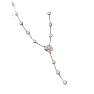 Elegant zircon camellia flower pendant pearl necklace for women on white background