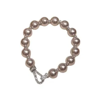 Elegant French style pearl bracelet featuring a sparkling zircon encrusted horseshoe buckle