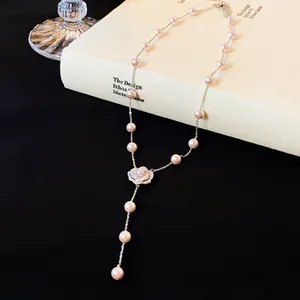 Close-up detailed view of elegant camellia flower pendant pearl necklace with zircons