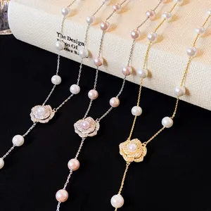 Detail view of elegant camellia pendant necklaces with shimmering zircons and pearls.