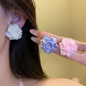 Elegant resin flower stud earrings with iridescent pearl luster and silver needles