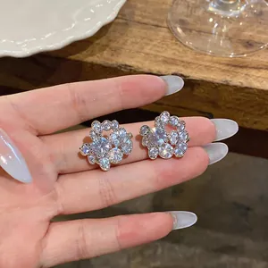 Close-up of silver-tone round clip-on earrings with sparkling cubic zirconia clusters
