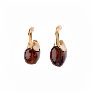 Elegant C-shaped gold hoop earrings with amber resin drop pendants for women.