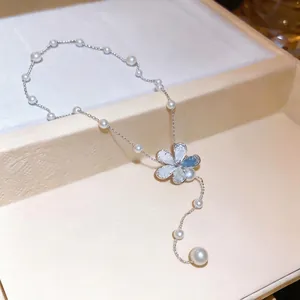 Elegant silver-toned necklace featuring small pearl beads and a sparkling crystal flower pendant