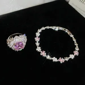 Elegante set di gioielli a fiore con zirconi rosa e perle su velluto nero di lusso