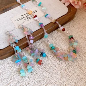Macro shot of colorful resin flower and bead details on a dopamine style jewelry set