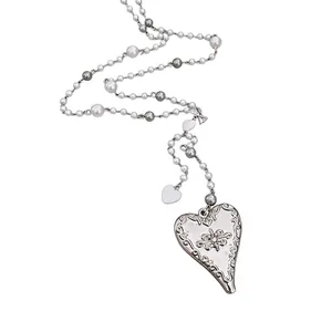 Elegant pearl beaded necklace with vintage engraved heart pendant, adjustable length