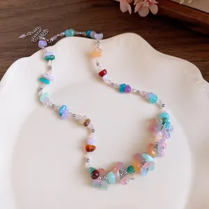 Close-up of a colorful dopamine style necklace with resin flowers and irregular stone beads