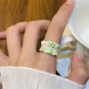 Macro view showing detail of fresh green drip oil flower ring with wavy gold edges