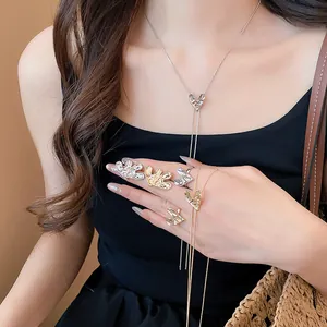 Detailed view of wrinkled heart jewelry set with Y-necklace and rings on model