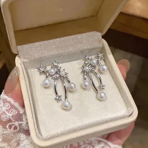 Elegant star and pearl drop earrings with shimmering rhinestones in a cream gift box