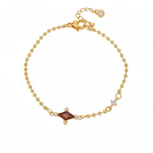 Elegant gold bead chain bracelet with purple rhombus gemstone and sparkling zircon accents.