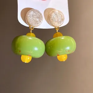 Elegant resin drop earrings with vibrant green and yellow beads on silver needles
