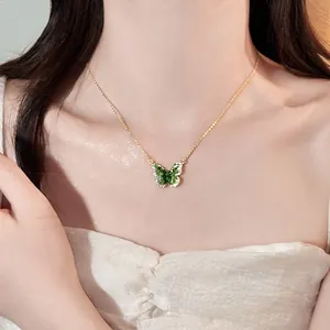 Elegant green gradient butterfly pendant necklace shown close-up on a model's neck.