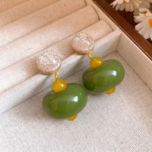 Elegant minimalist resin dangle earrings in green and cream with silver needles