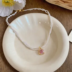 Elegant French style pearl necklace featuring a square pink zircon pendant on a cream plate