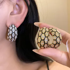 Close-up of vintage honeycomb earrings with gold plating and sparkling cubic zirconia