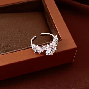 Elegant silver open ring featuring a large sparkling round cubic zirconia with side stones