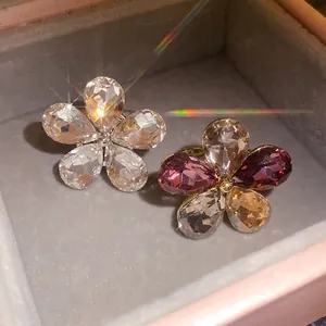 Sparkling crystal flower open rings with luxury prism light in a jewelry box.