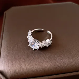 Close-up of an elegant silver open ring with a sparkling round zirconia centerpiece