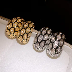 Close-up detail of luxury vintage checkered stud earrings with 18k gold plating and zircon