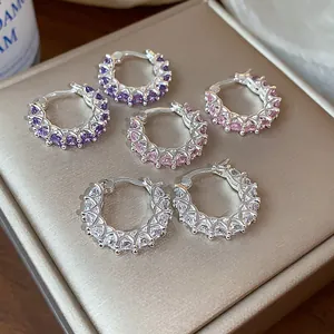 Macro view of sparkling cubic zirconia hoop earrings in purple, pink and white colors
