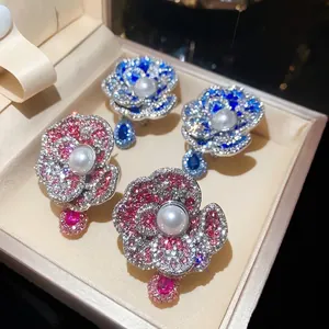Elegant pearl and rhinestone flower earrings featuring pink and blue floral jewelry designs