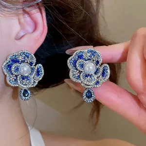 Elegant vintage pearl flower stud earrings with blue crystals and silver finish for women