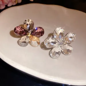 Detailed macro view of elegant flower rings featuring sparkling water-drop crystal petals