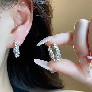 Close-up view of sparkling zircon round hoop earrings with elegant silver setting