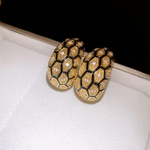 Detailed view of 18k gold plated vintage stud earrings with honeycomb zircon patterns.
