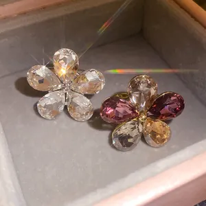 Macro view of crystal flower rings with sparkling petals resting in a jewelry box