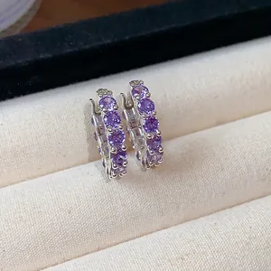 Elegant silver-toned hoop earrings set with sparkling purple round-cut zirconia stones.