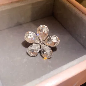 Macro detail of elegant flower open ring with clear pear-cut crystals in jewelry box