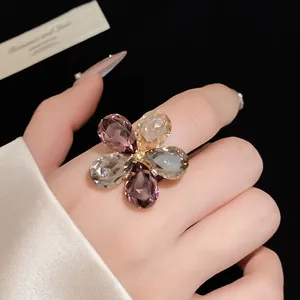 Detailed macro shot of a sparkling crystal flower ring with five multi-color petals