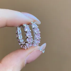 Exquisite macro detail of sparkling pink cubic zirconia silver hoop earrings for women