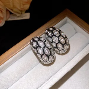 Close-up detail of 18k gold plated vintage earrings with zircon honeycomb pattern