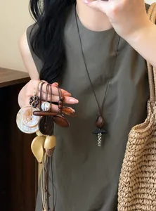 Detailed view of handmade ethnic resin and wood bead necklace on model