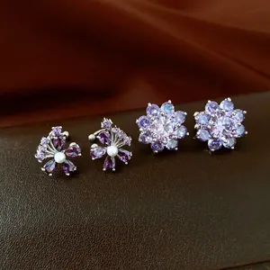 Detailed view of elegant purple zircon floral ear cuffs with pearl accents on leather.