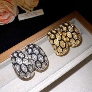 Close-up of 18k gold plated stud earrings featuring a sparkling zircon honeycomb pattern