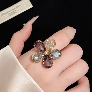 Close-up detail of a luxury vintage flower ring with colorful teardrop crystals.