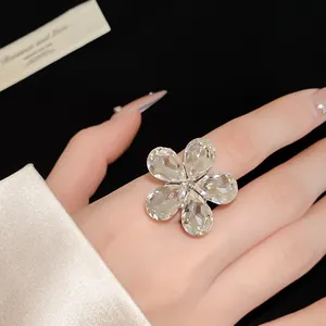 Exquisite close-up view of elegant crystal flower adjustable ring worn on finger for women