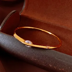 Elegant vintage gold-plated round bracelet with oval zircon inlay on a leather box